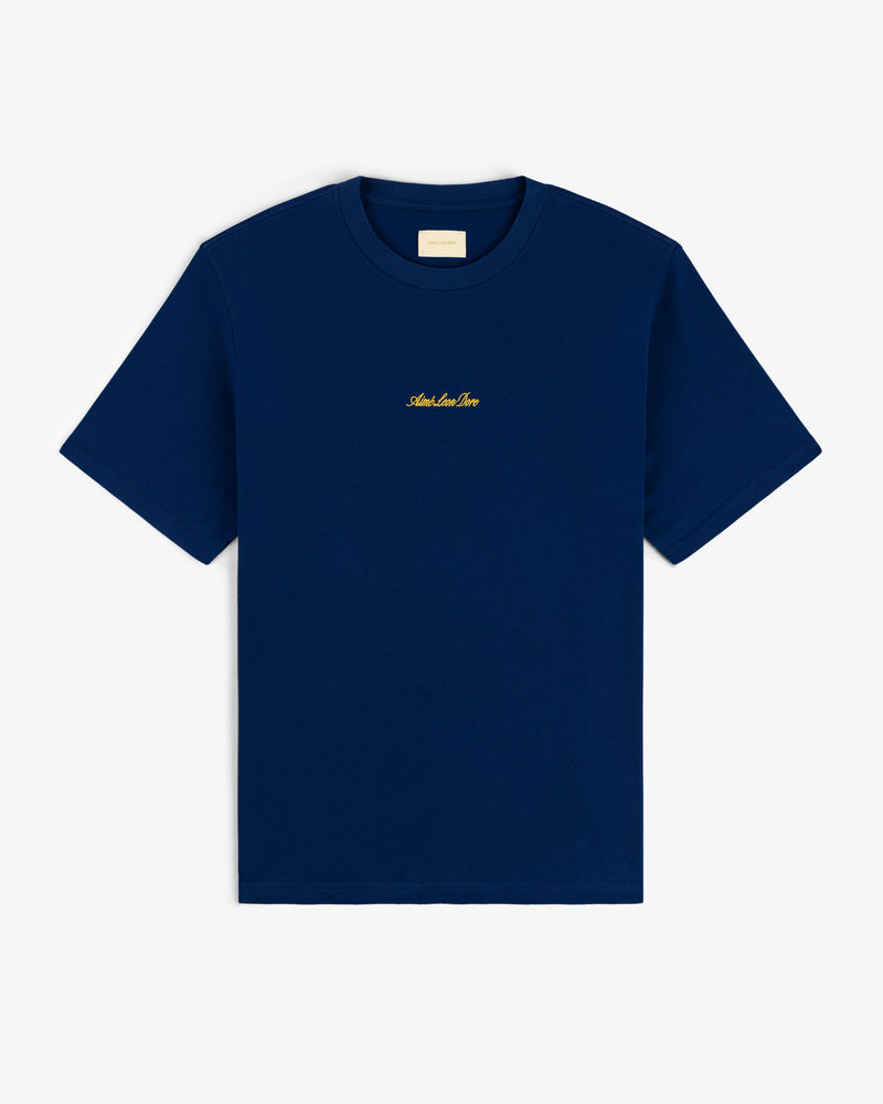 Navy Embroidered Logo Tee with short sleeves and small gold text centered on the chest.