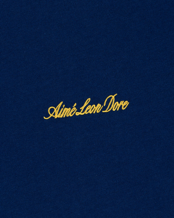 Navy blue Embroidered Logo Tee with yellow Aimé Leon Dore cursive text.