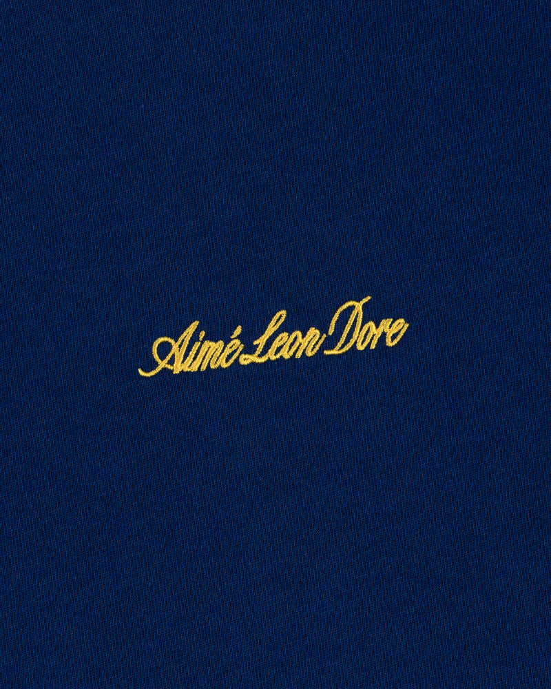 Navy blue Embroidered Logo Tee with yellow Aimé Leon Dore cursive text.