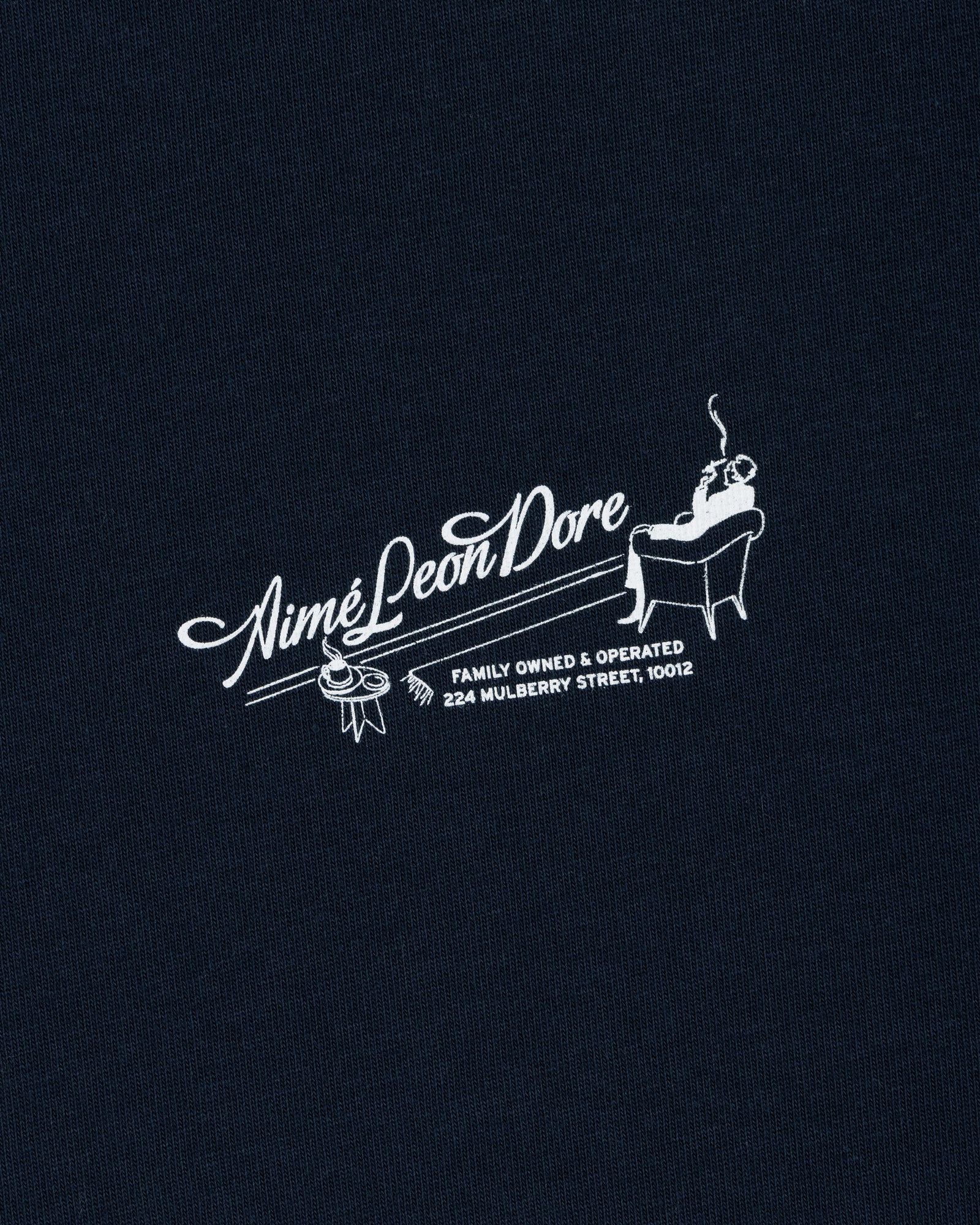 Pappoús Logo Tee: White Aimé Leon Dore logo of a man relaxing, text reads Family Owned & Operated, 224 Mulberry St, 10012.