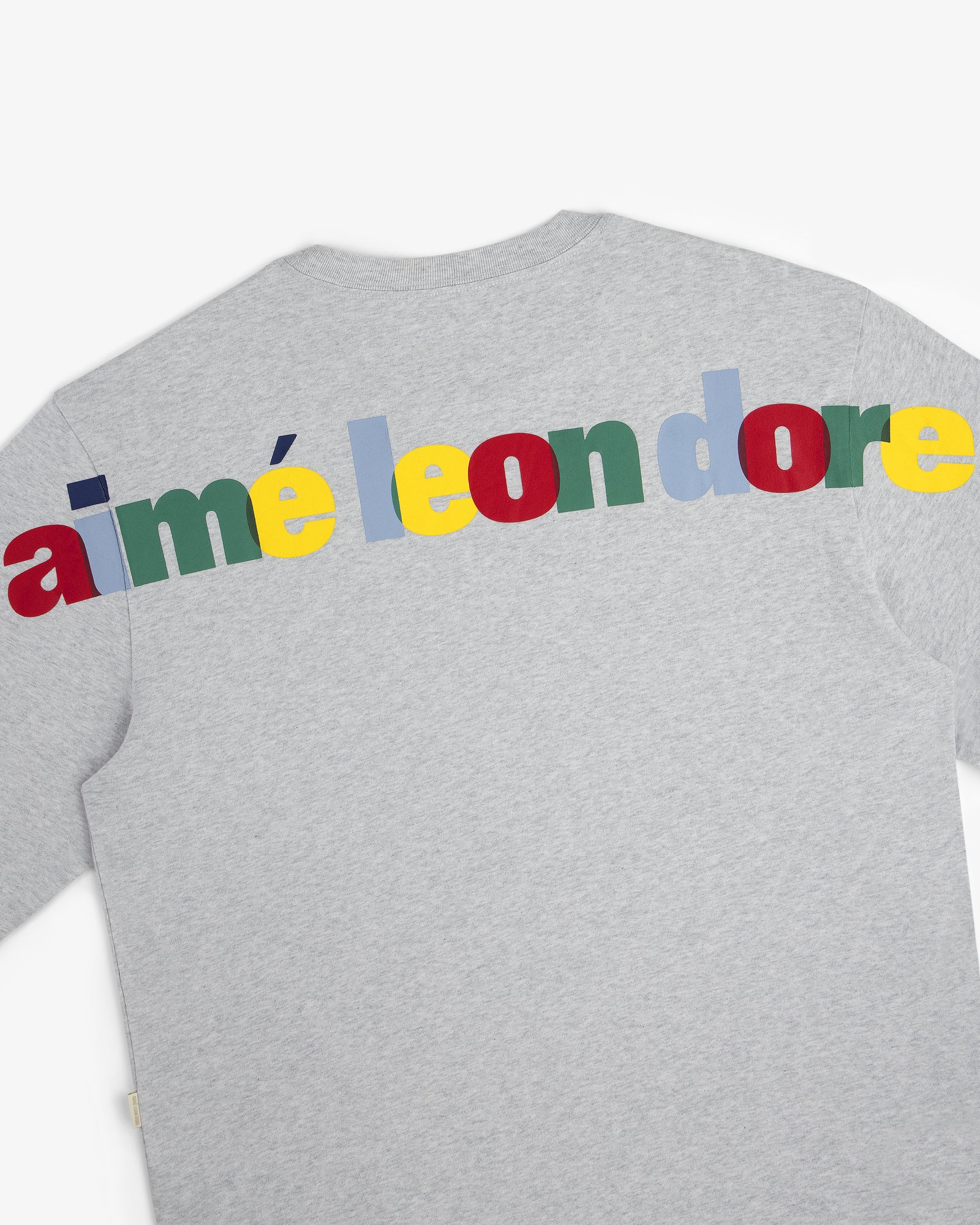 The Long-Sleeve Souvenir Tee is a gray shirt with "aimé leon dore" in colorful, bold letters across the upper back.