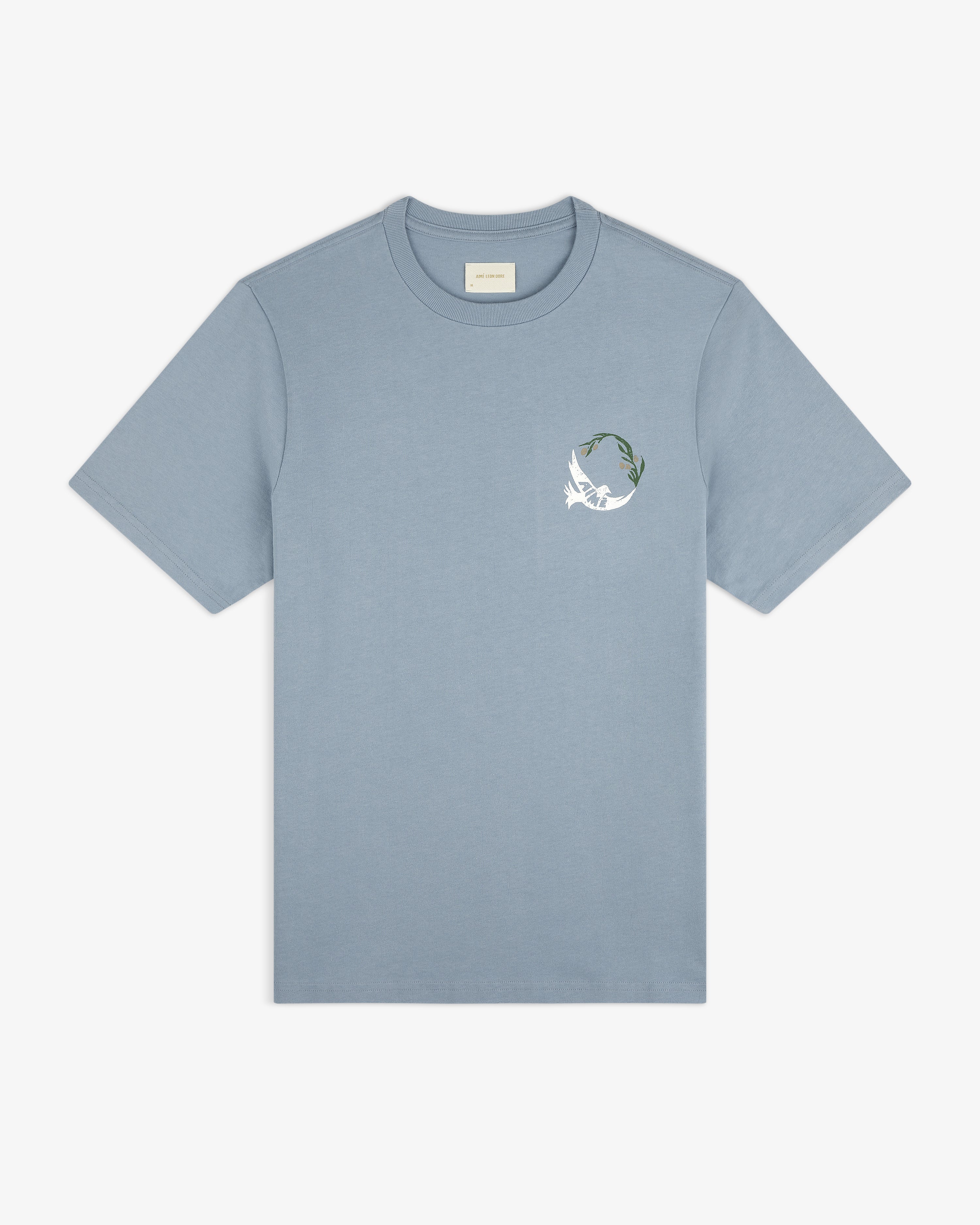 Woodblock Dove Tee: light blue short-sleeve featuring a small white bird and green leaves on the left chest.