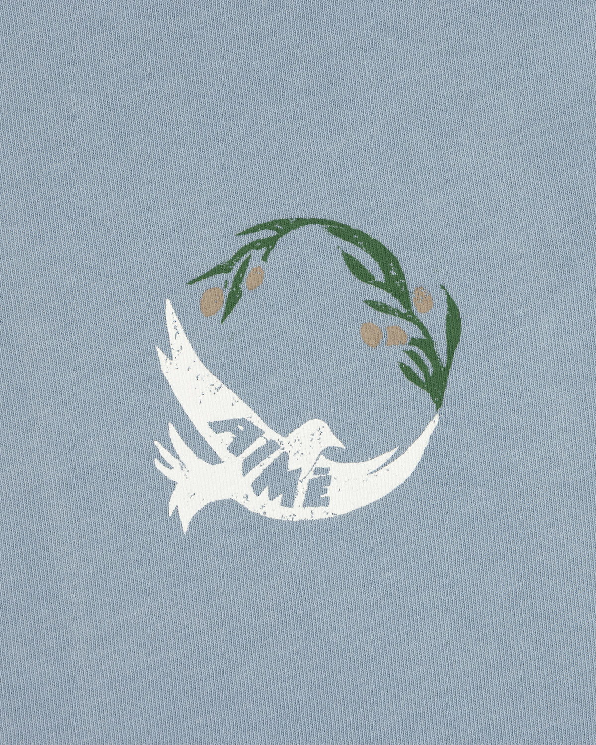 White dove with TIME on its wing and olive branch above on a light blue Woodblock Dove Tee.