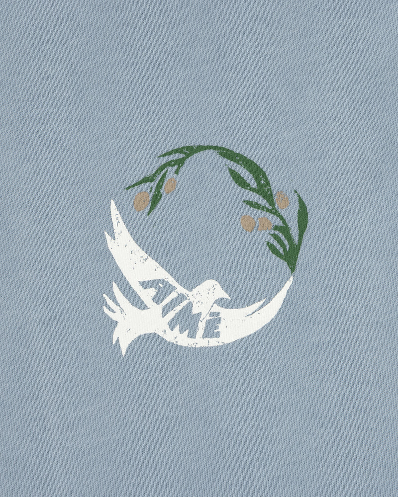 White dove with TIME on its wing and olive branch above on a light blue Woodblock Dove Tee.