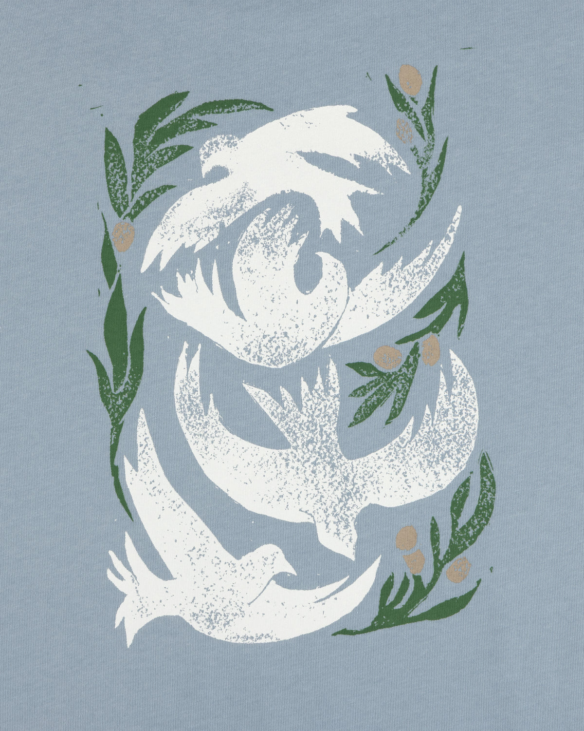 Three white doves soar among leaves and berries on a light blue Woodblock Dove Tee.