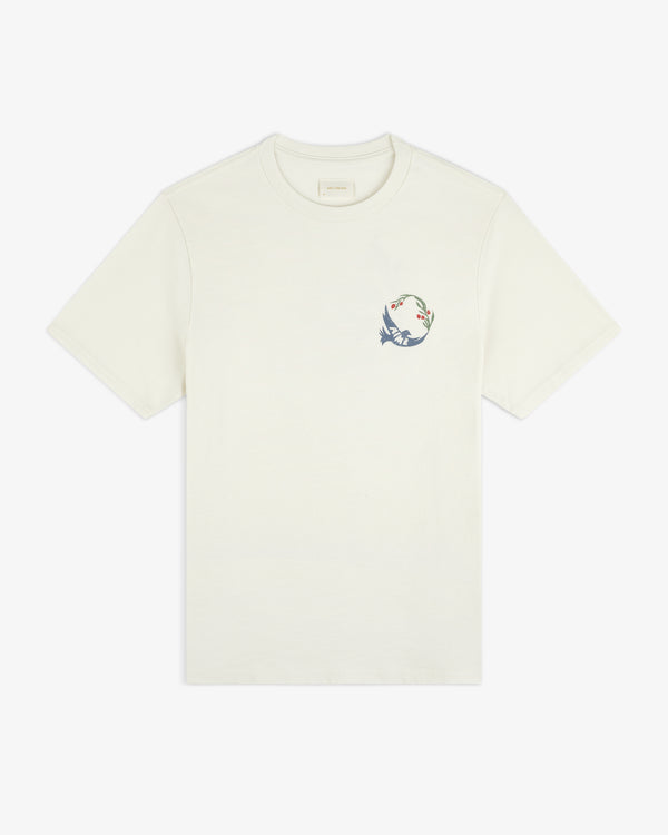 Woodblock Dove Tee: Off-white short-sleeve tee with a small bird and branch graphic on the left chest.