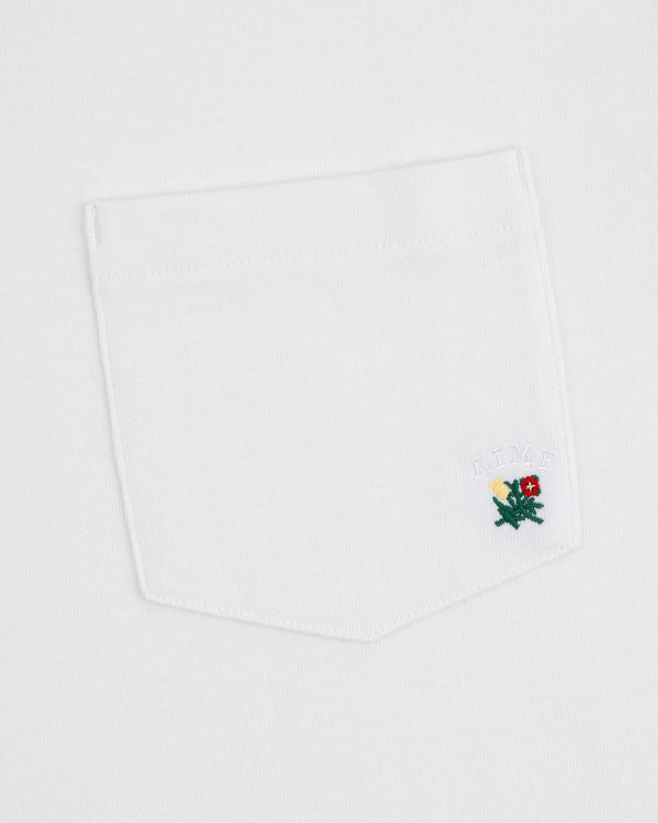 Crest Pocket Tee with a white pocket, small green embroidered dragon, and 'AIME' above it.