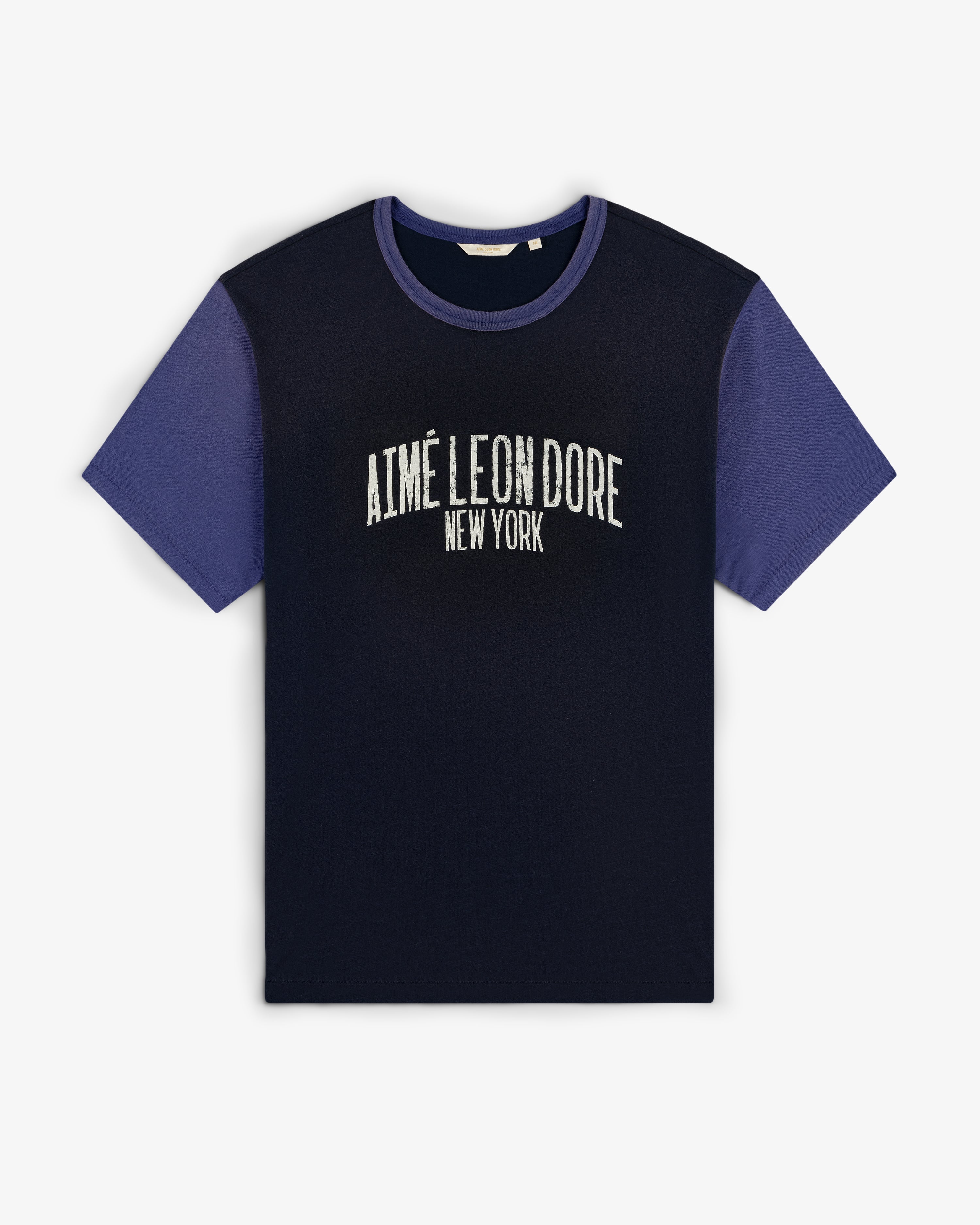 Washed Ringer Tee with dark body, blue sleeves, and AIMÉ LEON DORE NEW YORK text on the front.