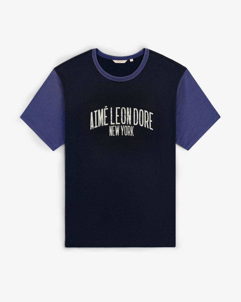 Washed Ringer Tee with dark body, blue sleeves, and AIMÉ LEON DORE NEW YORK text on the front.