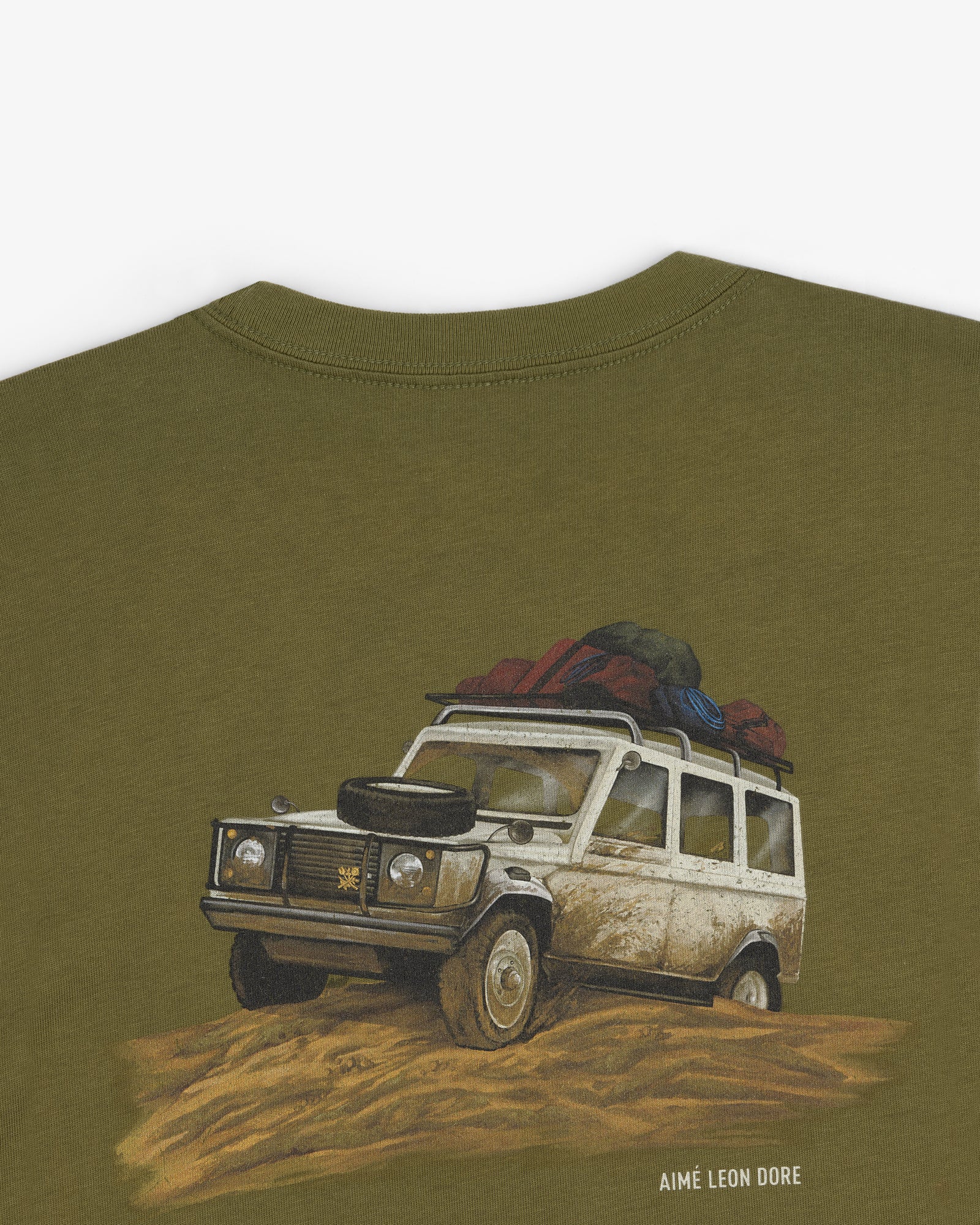 Safari Tee with illustrated off-road vehicle in mud and “AIMÉ LEON DORE” printed below.