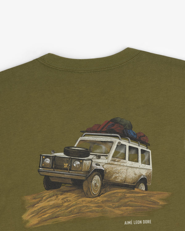 Safari Tee with illustrated off-road vehicle in mud and “AIMÉ LEON DORE” printed below.
