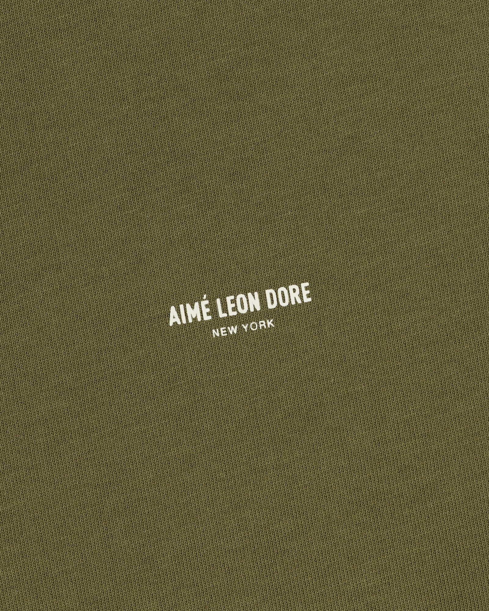 Olive green Safari Tee with small white AIMÉ LEON DORE NEW YORK text printed in the center.