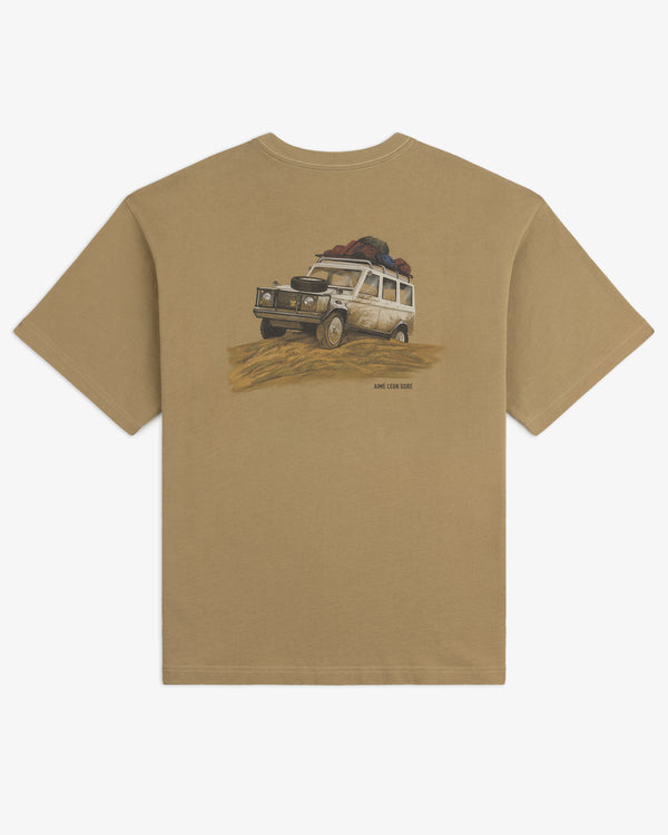 Safari Tee: Tan t-shirt featuring a white off-road vehicle loaded with gear driving on sand.