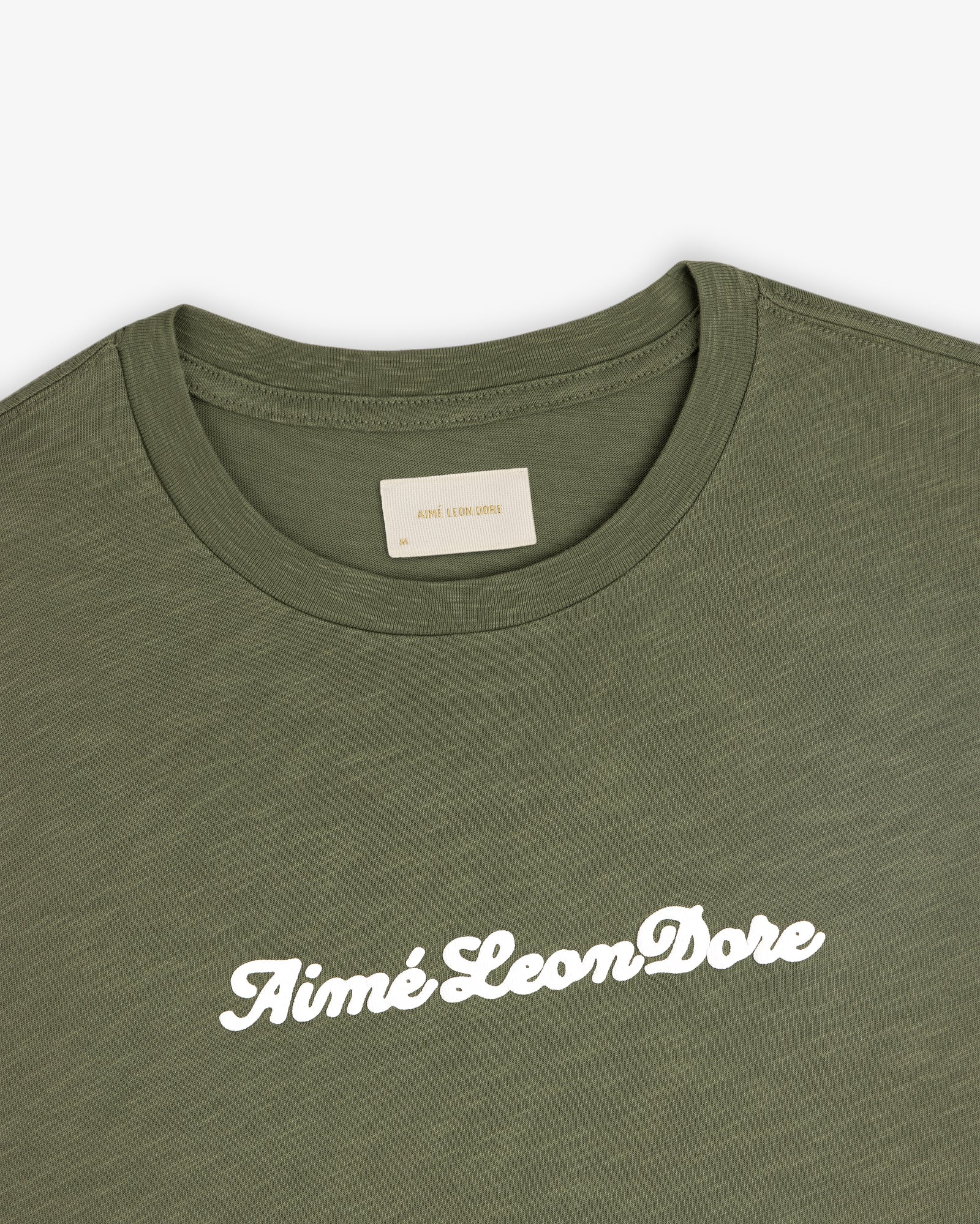 Olive green Puff Print Slub Logo Tee with Aimé Leon Dore in white cursive across the chest.