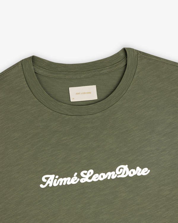 Olive green Puff Print Slub Logo Tee with Aimé Leon Dore in white cursive across the chest.