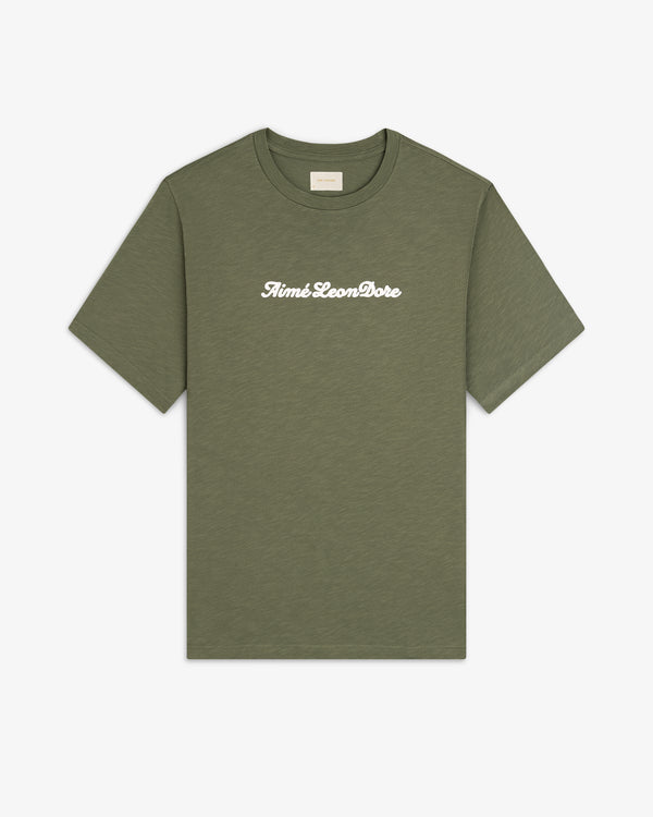 Olive green Puff Print Slub Logo Tee with “Aimé Leon Dore” in white script across the chest.