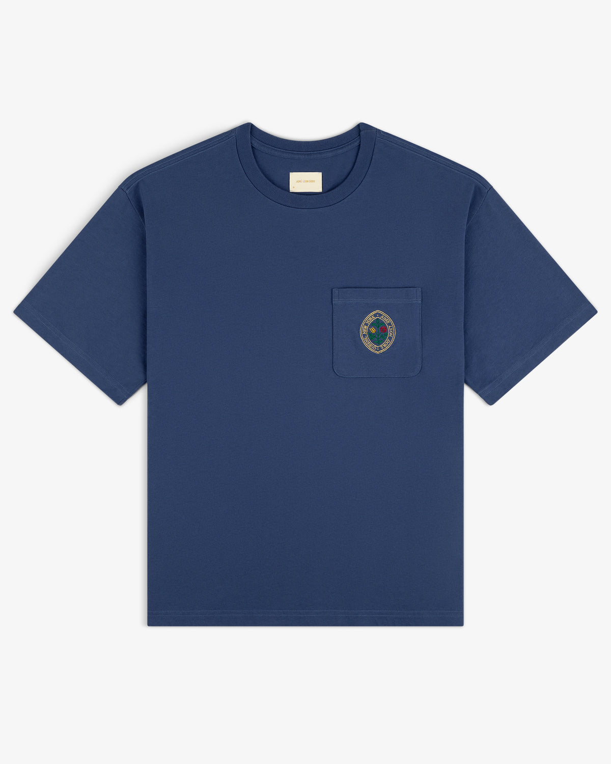 Botanical Crest Pocket Tee—navy blue short-sleeve shirt with chest pocket and circular embroidered crest.