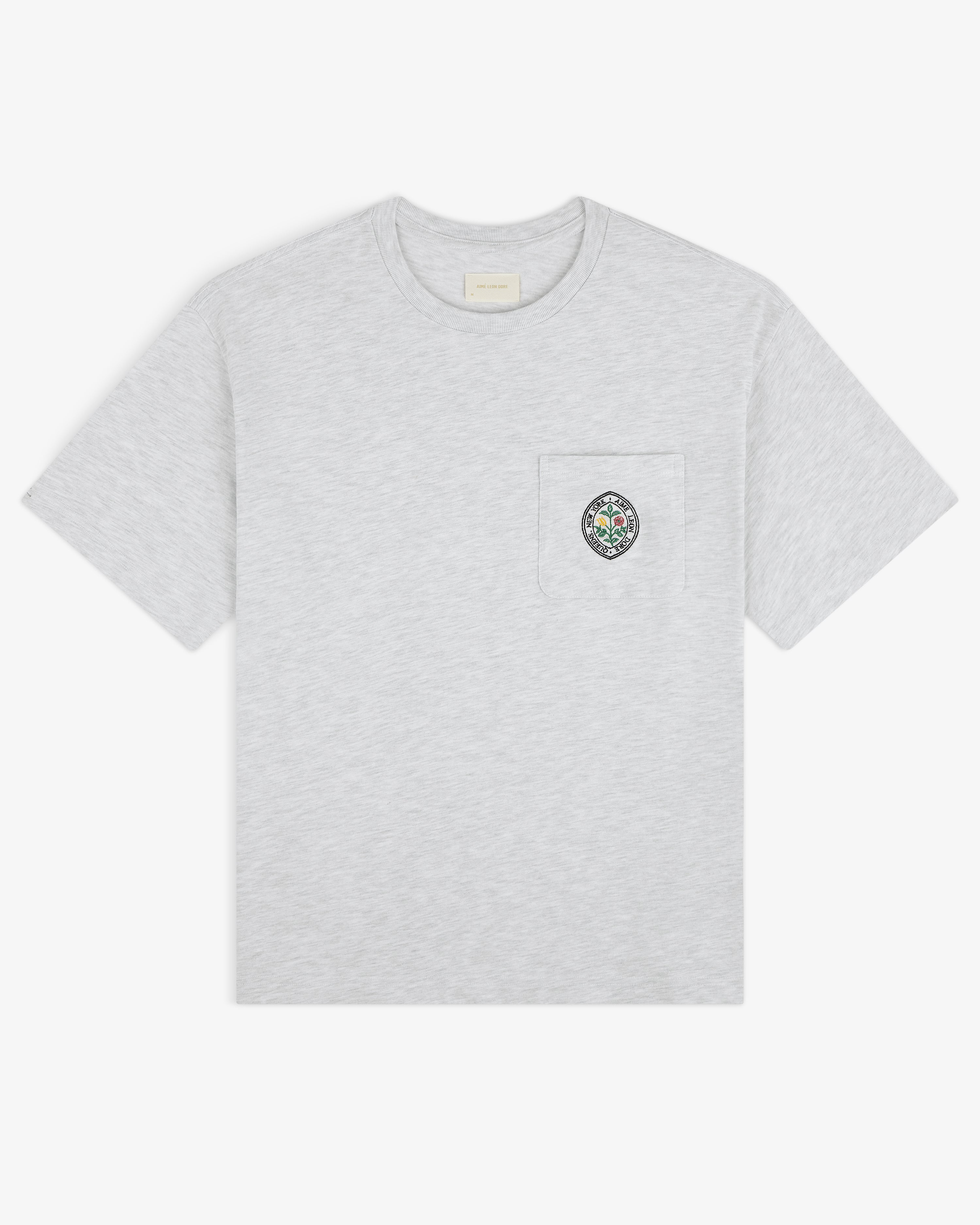 Light grey Botanical Crest Pocket Tee with short sleeves and a chest pocket featuring colorful circular embroidery.