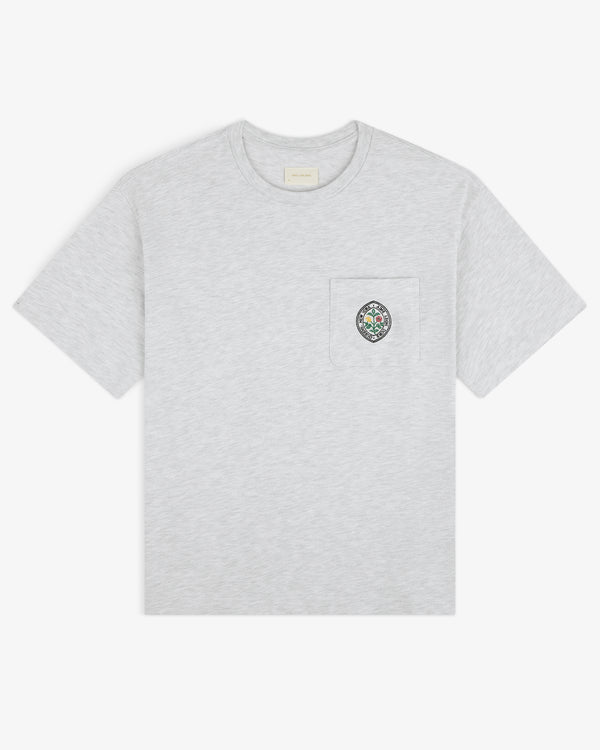 Light grey Botanical Crest Pocket Tee with short sleeves and a chest pocket featuring colorful circular embroidery.