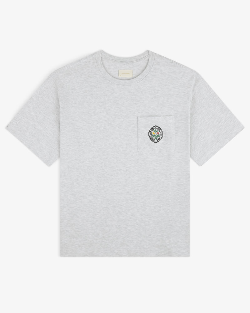 Light grey Botanical Crest Pocket Tee with short sleeves and a chest pocket featuring colorful circular embroidery.