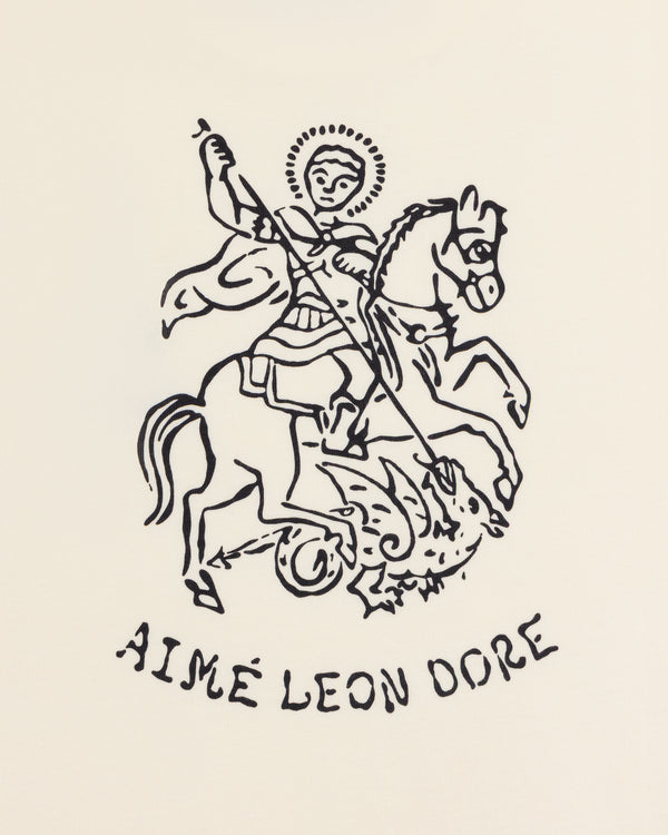 Line drawing of Saint George on horseback slaying a dragon, with "AIMÉ LEON DORE" on the Saint George Graphic Tee.