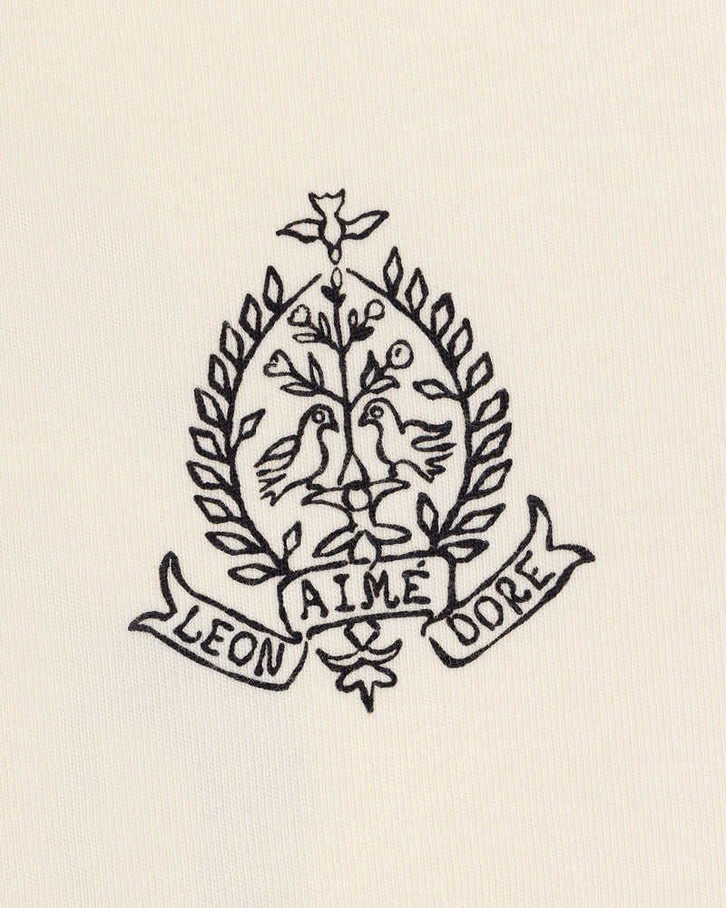 Black line art of two birds on branches in a laurel wreath, with LEON and DORE banners, on the Saint George Graphic Tee.