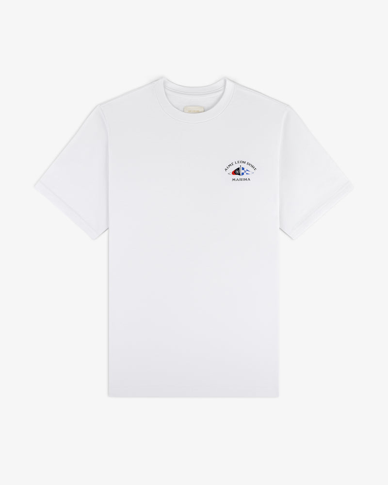 Marina Tee: white short-sleeve with small blue and red graphic and text on upper left chest.