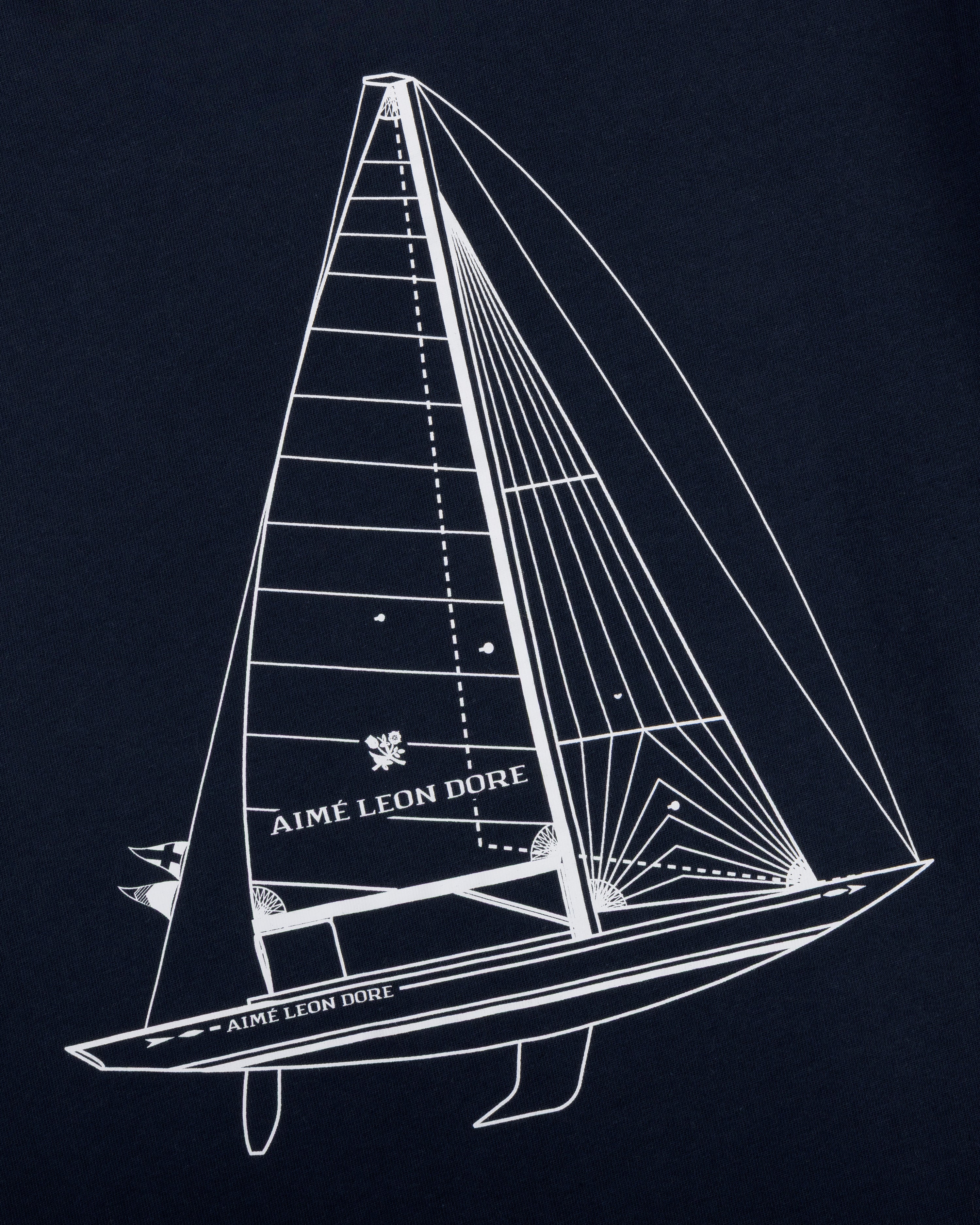 White line sailboat with Aimé Leon Dore text on sail and hull, on dark Marina Tee.