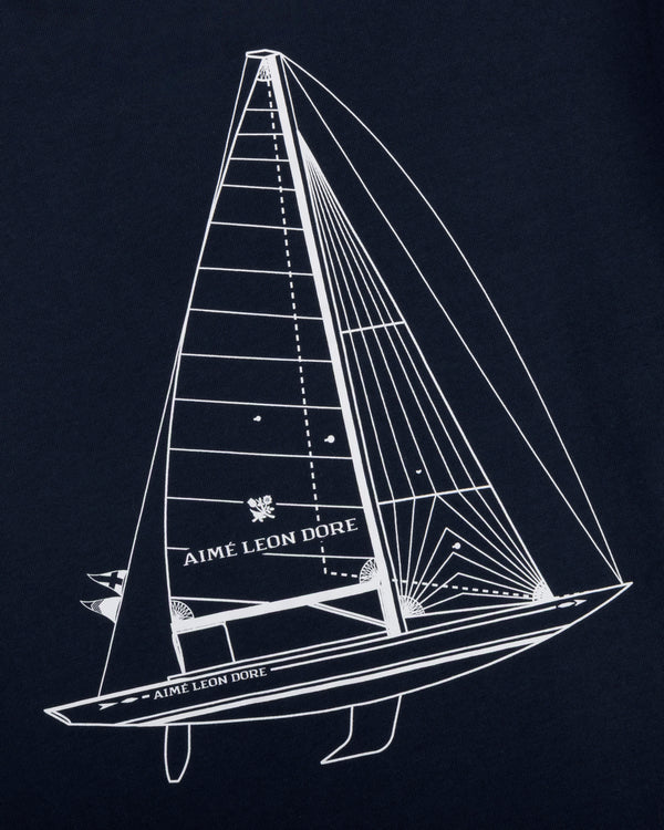 White line sailboat with Aimé Leon Dore text on sail and hull, on dark Marina Tee.