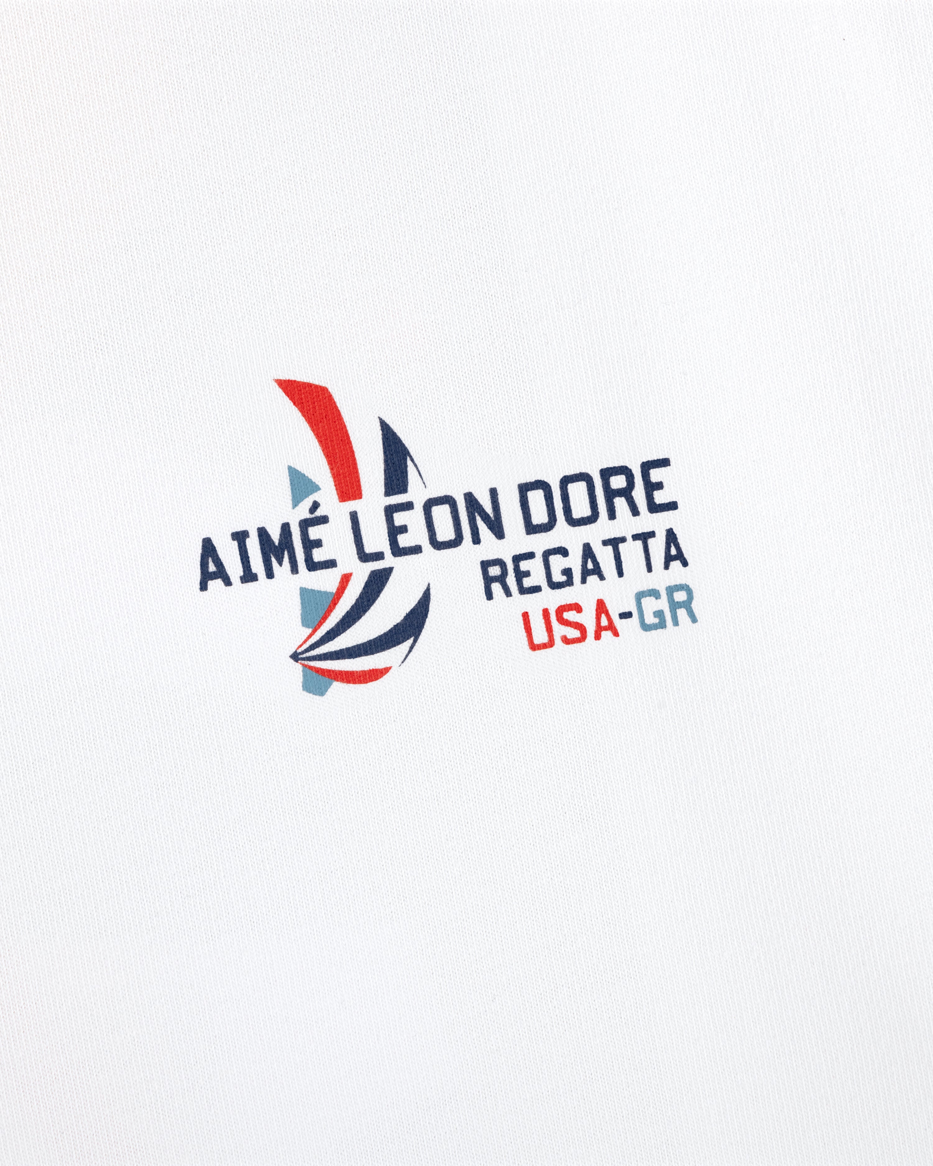 The Regatta Tee features "AIMÉ LEON DORE REGATTA USA-GR" and a red, blue, gray sailboat on white fabric.