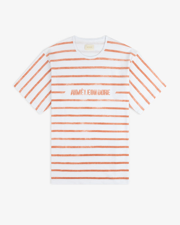 Slub Beach Tee: White with horizontal orange stripes and AIMÉ LEON DORE in orange text across the chest.
