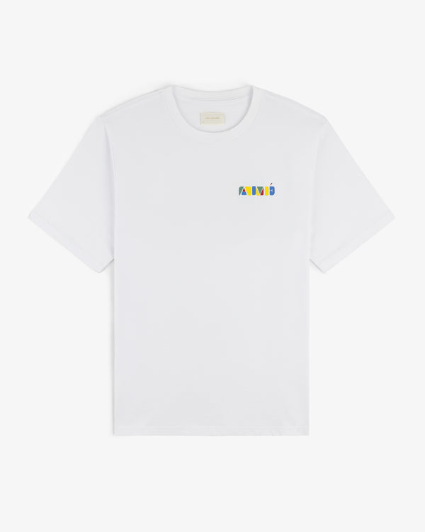 Stacked Logo Tee: White T-shirt featuring a small, colorful geometric logo on the left chest.