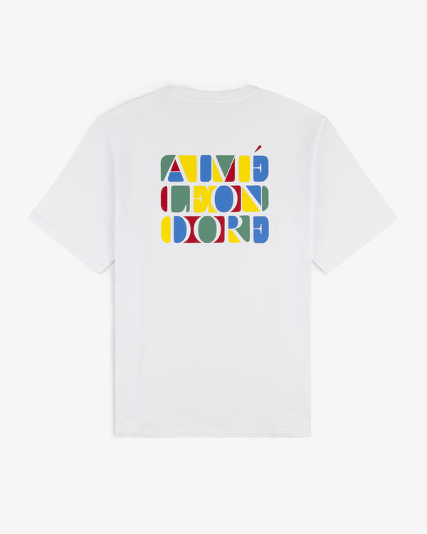 White Stacked Logo Tee with colorful geometric AIMÉ LEON DORE text on the back.