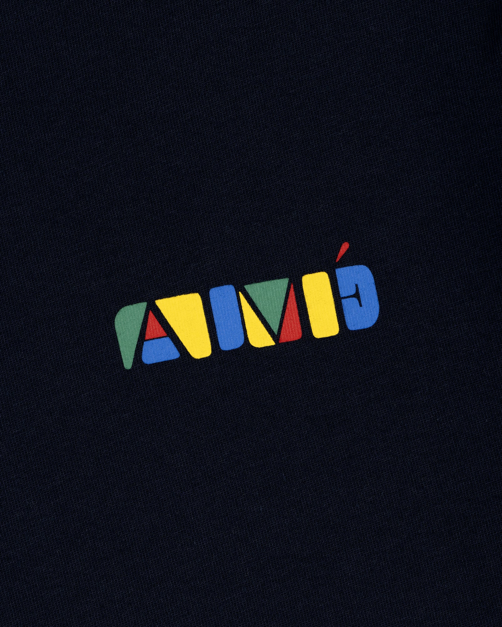 Colorful geometric AIMÉ letters on dark fabric, featured on the Stacked Logo Tee.