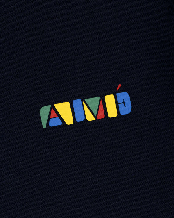 Colorful geometric AIMÉ letters on dark fabric, featured on the Stacked Logo Tee.