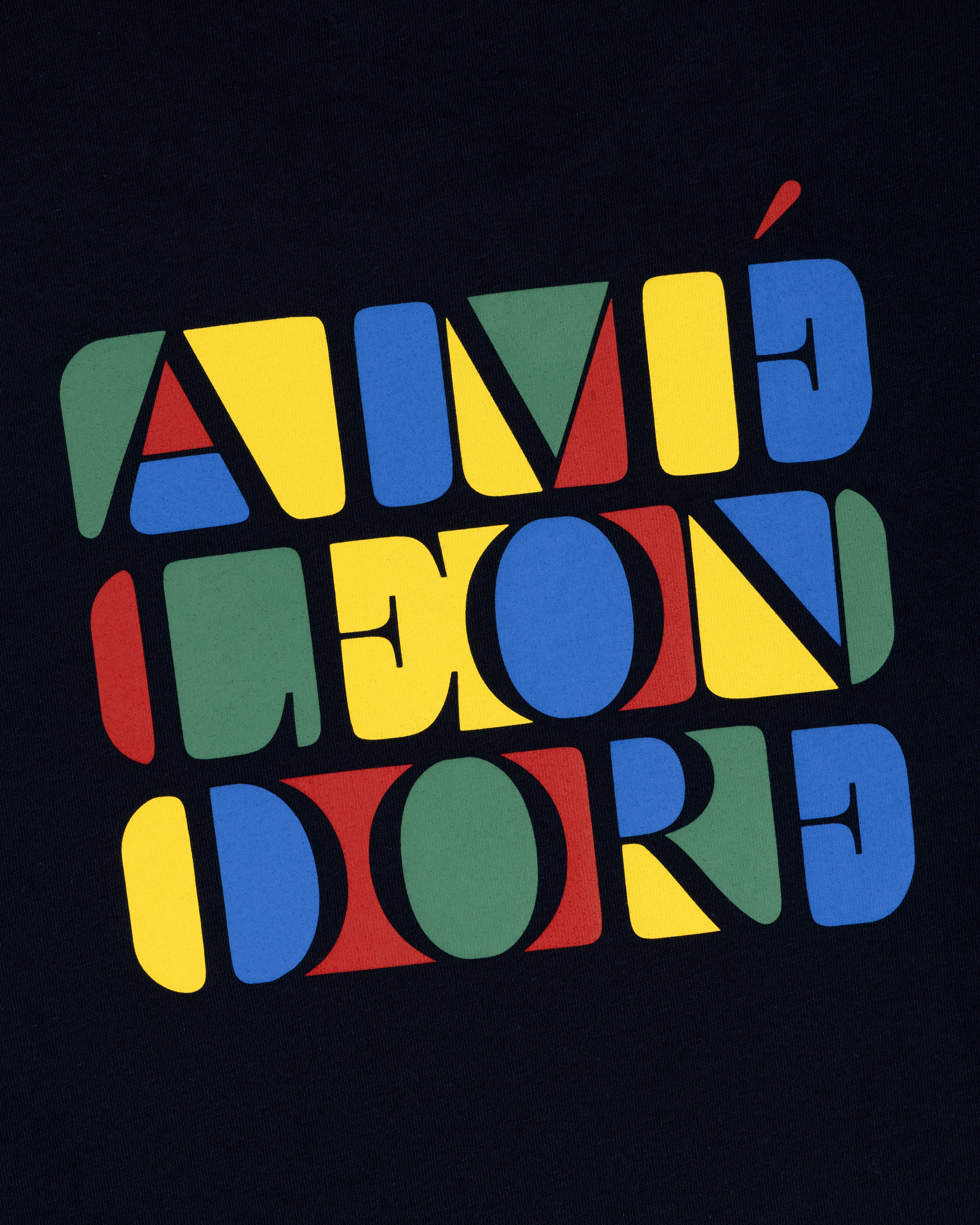 Stacked Logo Tee featuring colorful geometric letters spelling AIMÉ LEON DORE on a dark background.