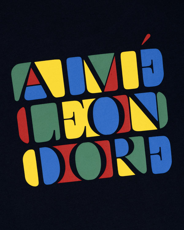 Stacked Logo Tee featuring colorful geometric letters spelling AIMÉ LEON DORE on a dark background.