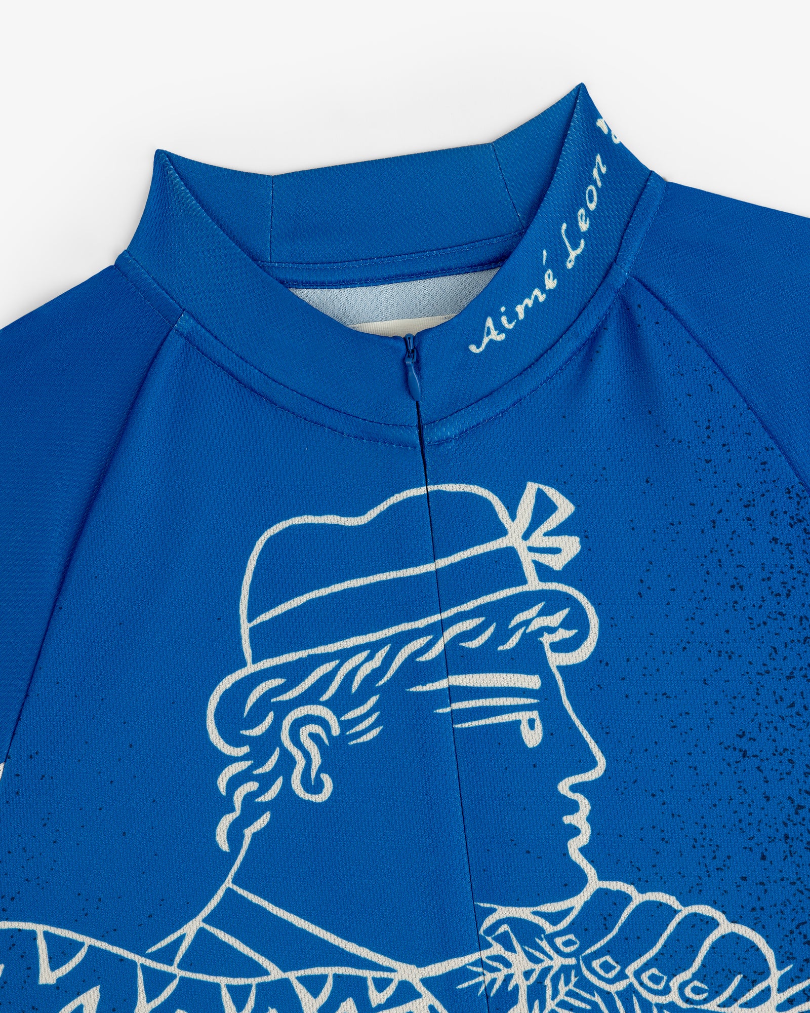 Close-up of the Fassianos Half-Zip Cycling Jersey in blue, featuring a white profile drawing and Aimé Leon on the collar.
