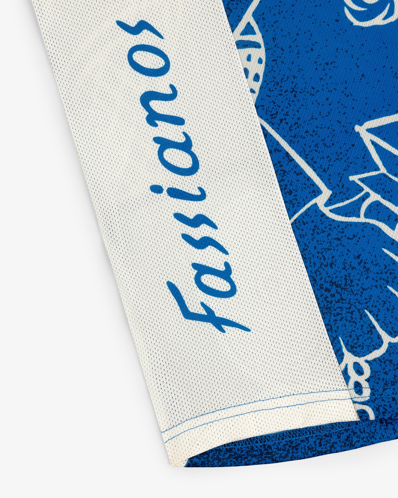 Close-up of the Fassianos Half-Zip Cycling Jersey featuring blue script on white and blue fabric.