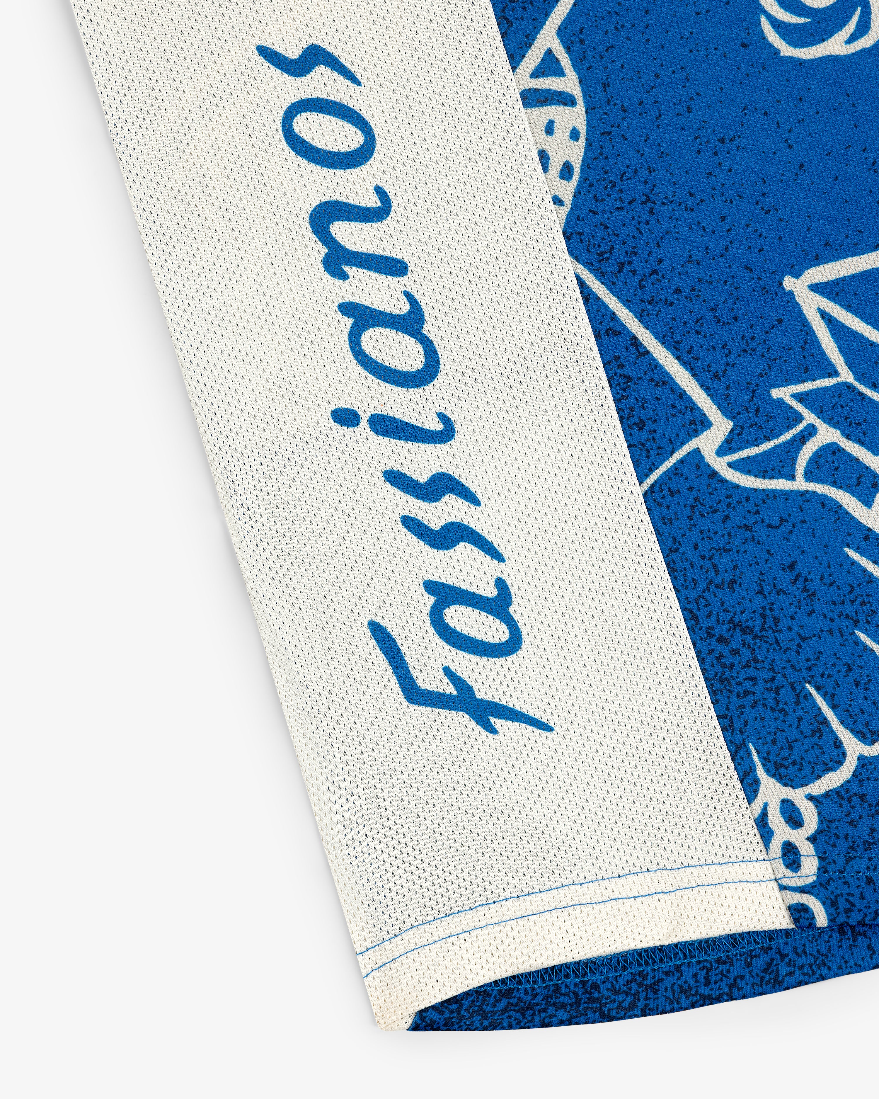 Close-up of the Fassianos Half-Zip Cycling Jersey featuring blue script on white and blue fabric.