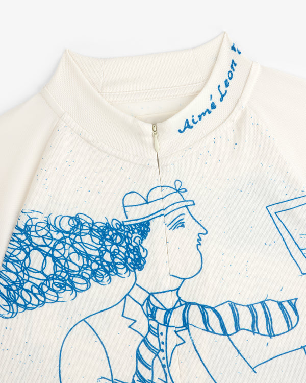 Cream-colored Fassianos Half-Zip Cycling Jersey with a blue line drawing and Aimé Leon text on the collar.