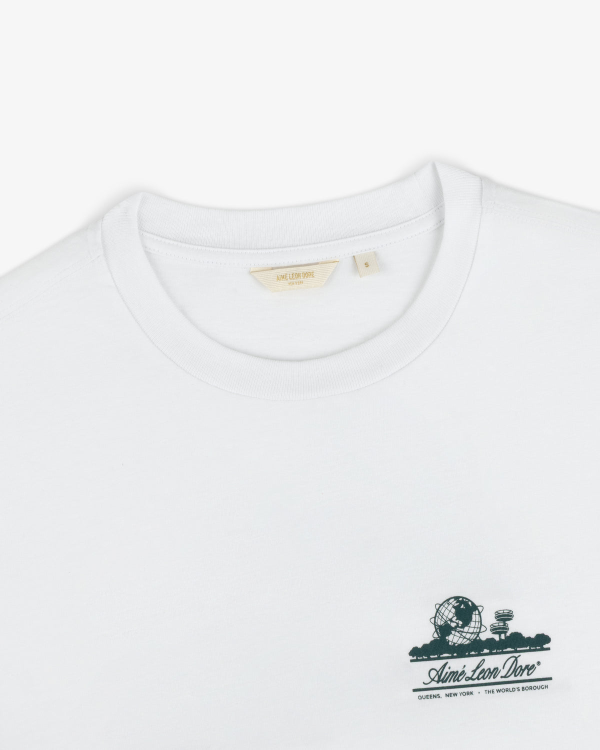 Cropped Aloe-Blend Unisphere Tee with small green graphic and Aimé Leon Dore text on the left chest.