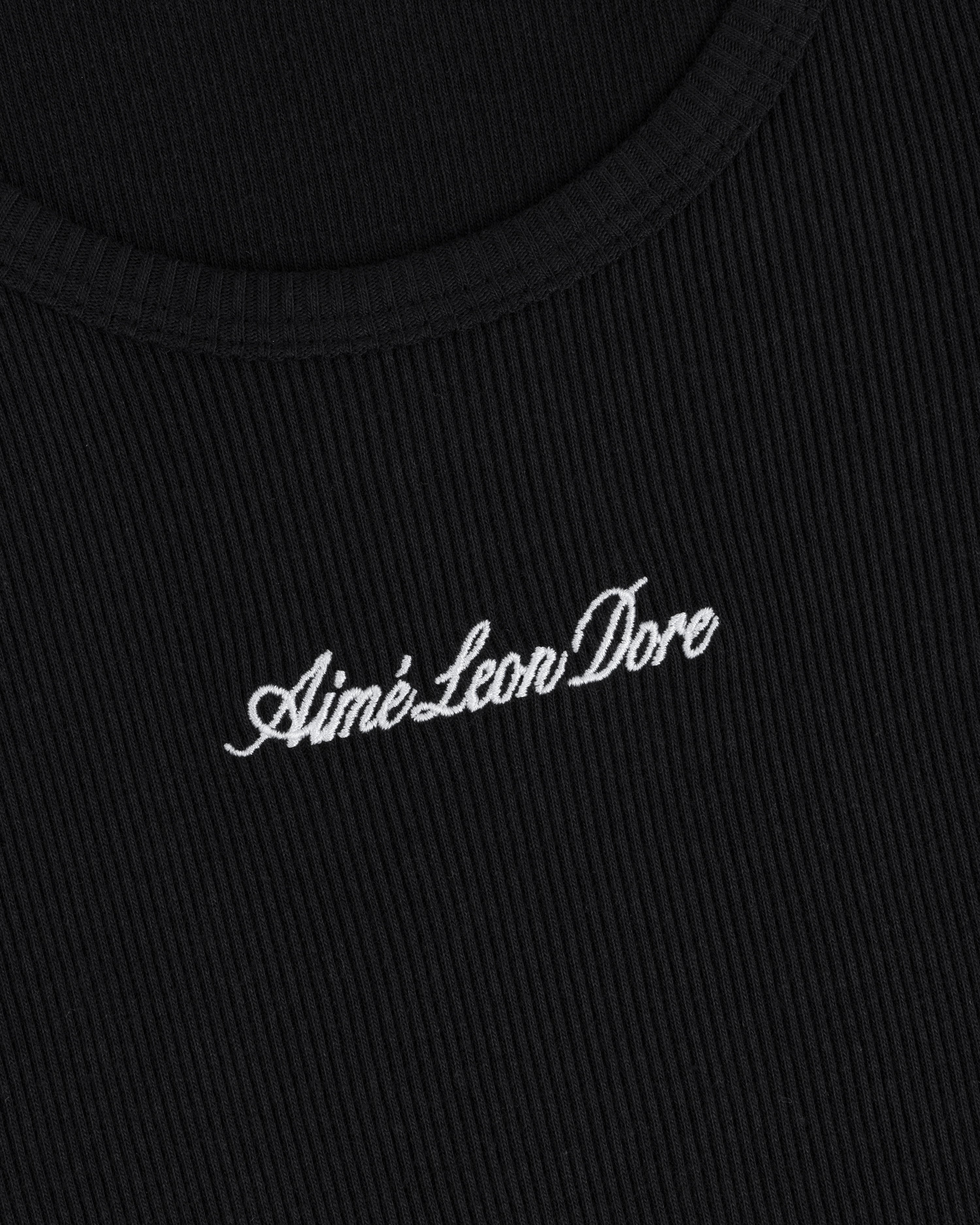Close-up of black ribbed Embroidered Logo Tank Top with “Aimé Leon Dore” in white cursive embroidery.