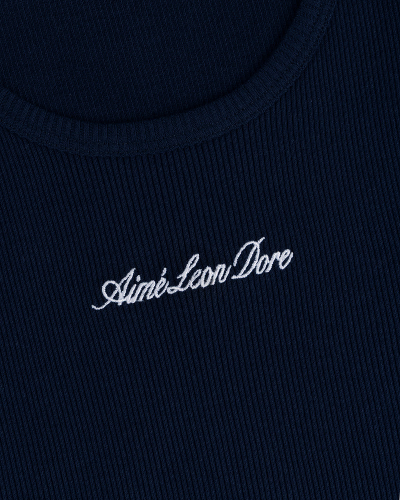 Close-up of navy ribbed fabric on the Embroidered Logo Tank Top with Aimé Leon Dore in white cursive.