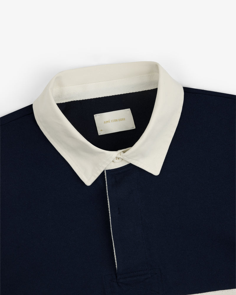 Navy blue Script Paneled Rugby with a white pointed collar and an AIME LEON DORE label inside.