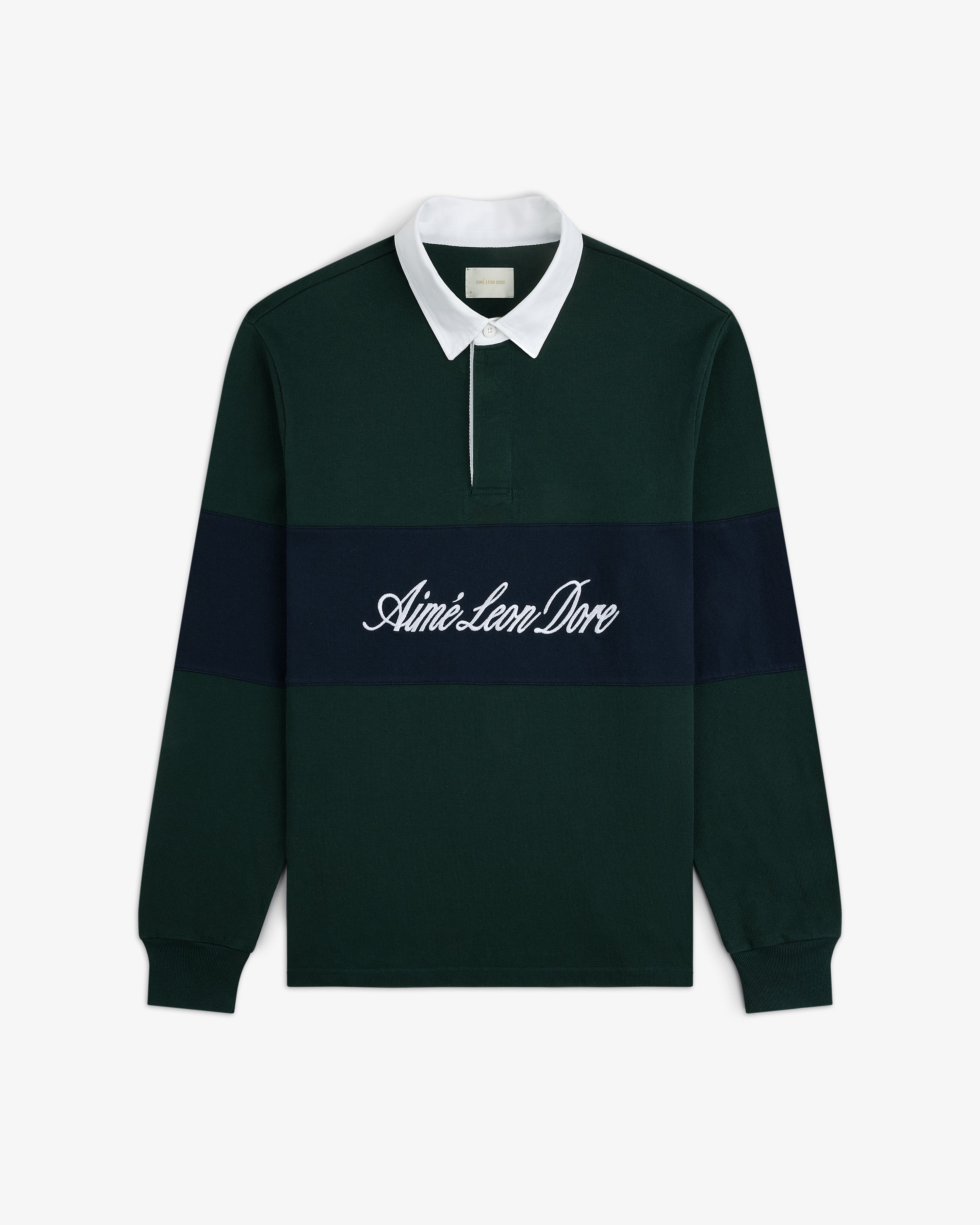 Dark green Script Paneled Rugby with white collar, navy stripe, and Aimé Leon Dore script embroidered on the chest.