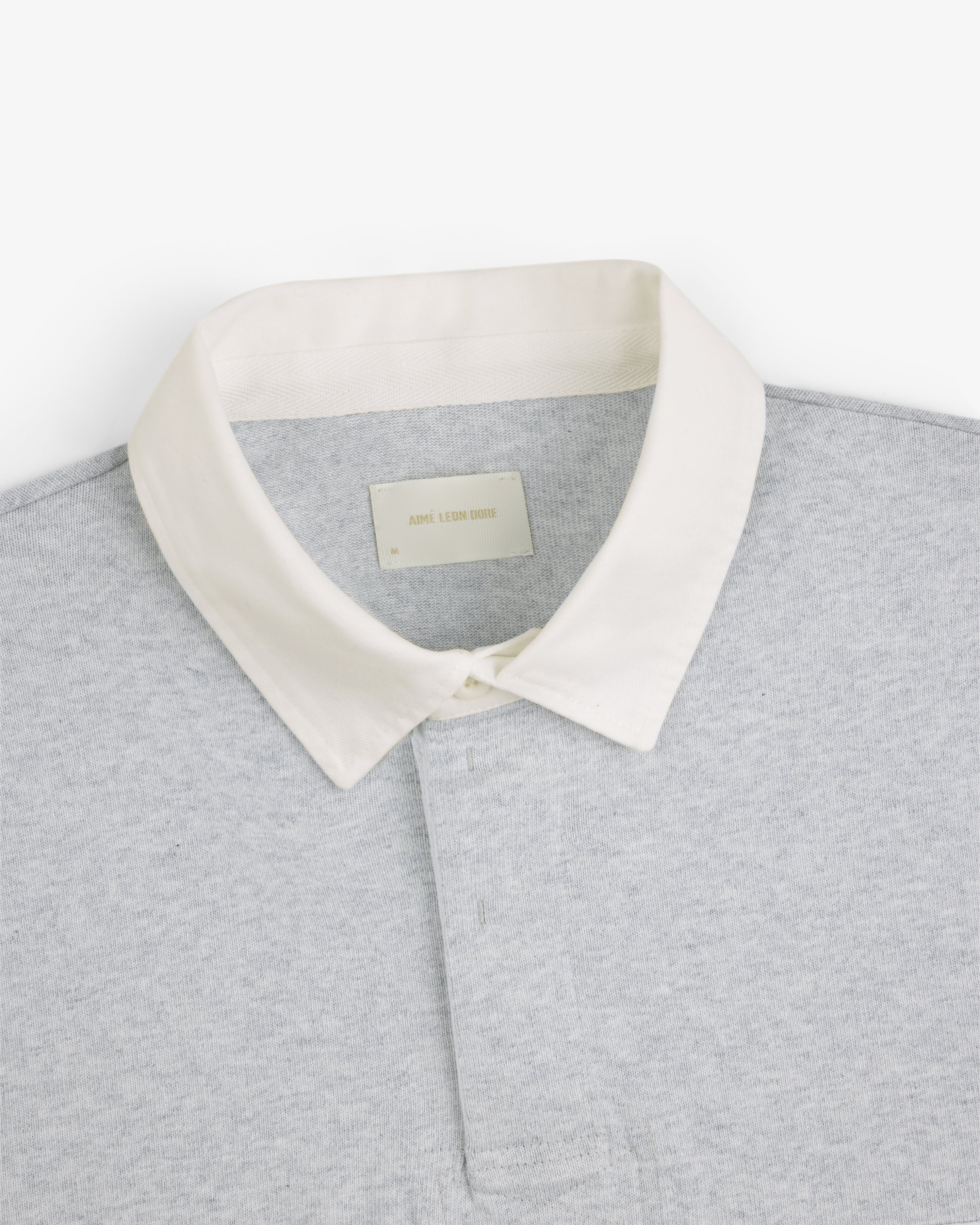 Script Paneled Rugby in light grey with a white collar, shown from the shoulders up on a plain white background.