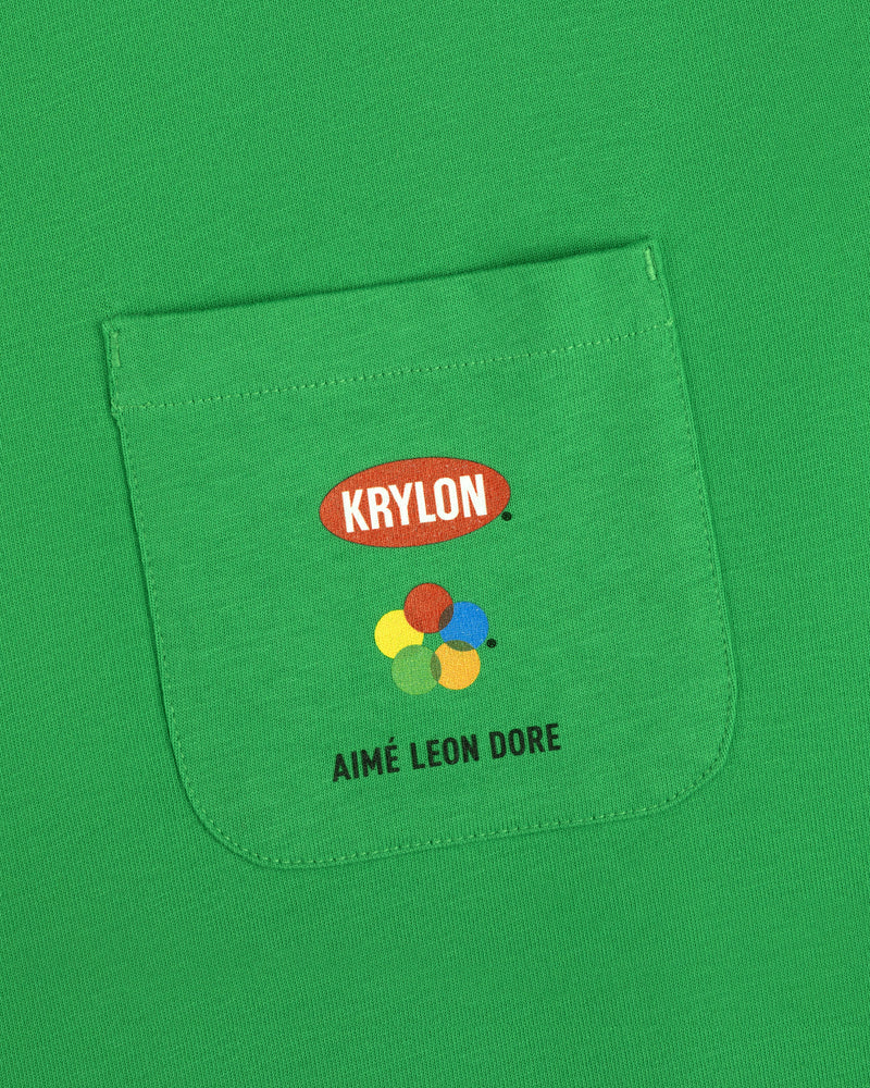 Krylon Pocket Tee: Green shirt with KRYLON logo, colorful paint splatters, and AIMÉ LEON DORE text below.