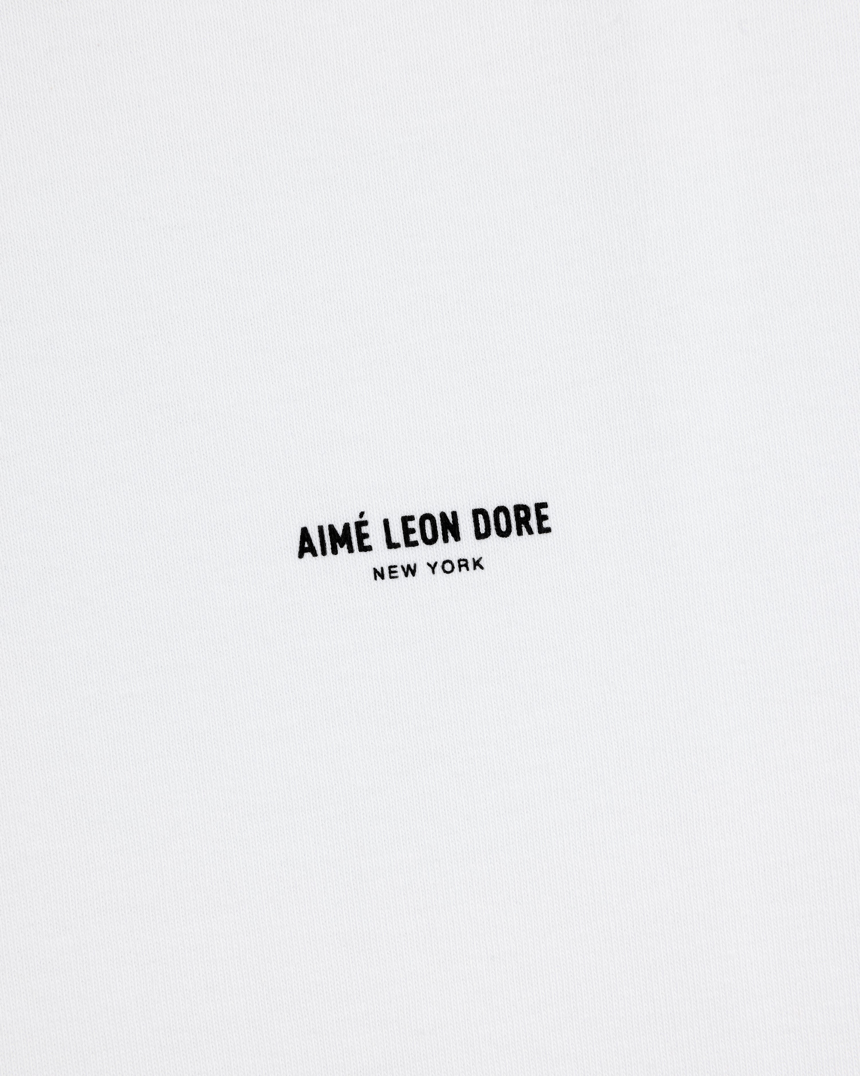 White Long-Sleeve Micro Logo Tee with small black "AIMÉ LEON DORE NEW YORK" text in the center.