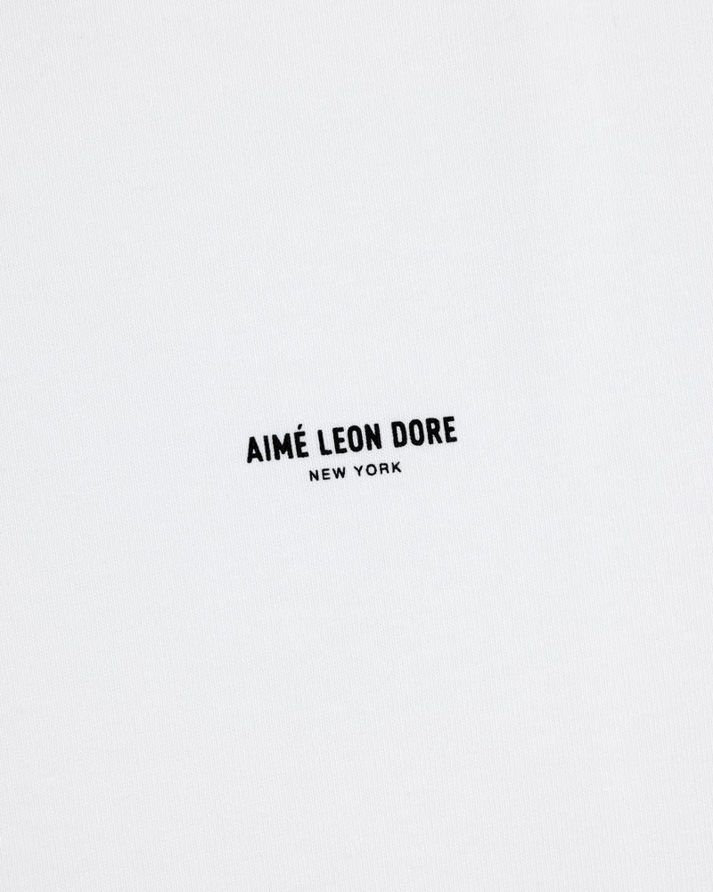 White Long-Sleeve Micro Logo Tee with small black "AIMÉ LEON DORE NEW YORK" text in the center.